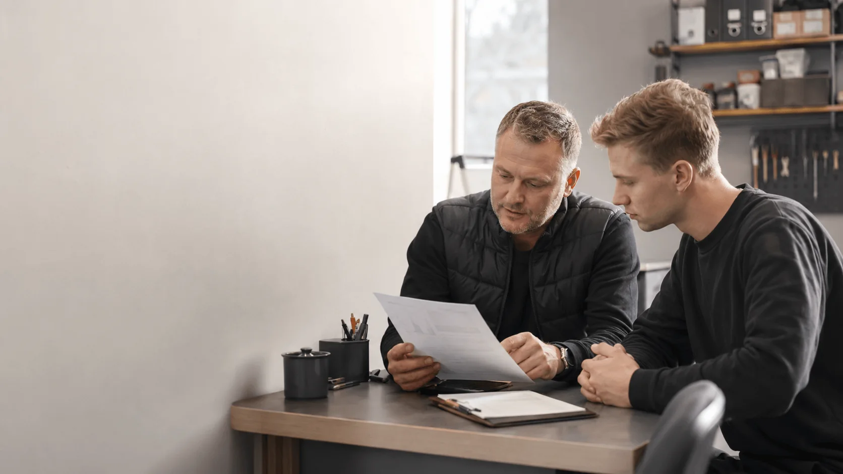 A manager and a new employee reviewing onboarding instructions together